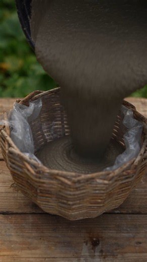 A woven basket and cement turn into stylish hanging planter.#DIYProject #ConcreteCraft #GardenDecor