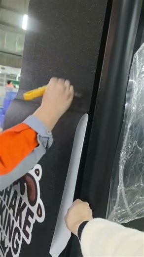 The process of applying stickers to the machine's exterior involves constantly scraping #sticker