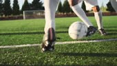 A soccer player does some fancy footwork while going up against other...