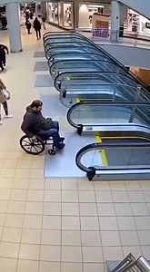 Wheelchair User Falls Down Mall Escalator Minneapolis, Minnesota — March 12, 2025 A shocking incident unfolded at a local shopping center Wednesday afternoon when a man in a wheelchair attempted to navigate a moving escalator. The footage, captured by security cameras, shows the moment the man's front wheels catch on the descending steps, causing the chair to tip forward and send him tumbling down the metallic stairs. Nearby shoppers reacted instantly as the man fell. A woman carrying shopping b