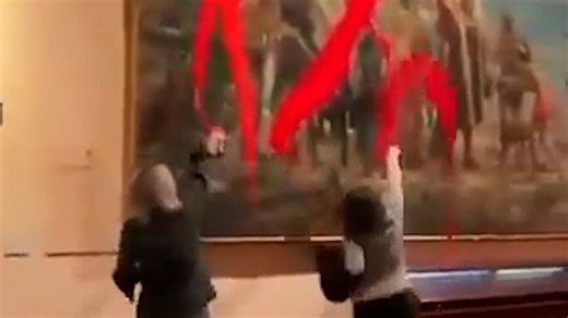 Two activists defaced an 1892 Christopher Columbus painting in Madrid with red paint, in protest of Spain’s National Day and colonial legacy. | USA TODAY Video