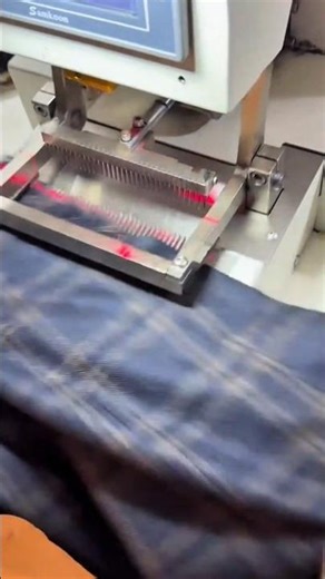 fusing blue checkered fabric manually using a modern heat press for garment work