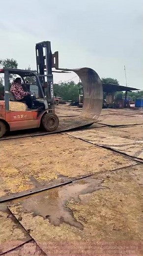 "Industrial Handling Showdown: Forklifts and Giant Metal Coils in 'Seamless Cooperation'"