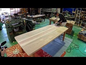 A large, sturdy nine-seater table made by the only craftsman in town.