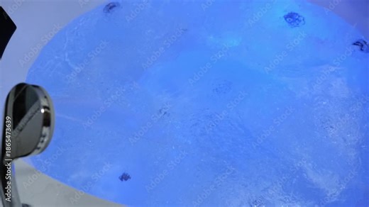 Jacuzzi.Bathing in a jacuzzi. Water bubbling in a jacuzzi with changing lighting. 4k footage