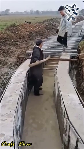 Use a crowbar to remove the precast concrete components from the U shaped drainage ditch