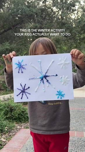 This might be our prettiest winter craft yet, and it’s SO easy! HOW TO MAKE COLORED SALT SNOWFLAKES: 1. Add salt to ziplock bags or bowls 2. Squeeze 3-4 drops of food coloring into each bag 3. Seal and shake until the salt is fully colored 4. Draw snowflake designs with white glue on cardstock 5. Sprinkle colored salt generously over the glue 6. Shake off excess salt and let dry completely The best part? Watching them get so proud of their unique creations. No two snowflakes are the same, just l