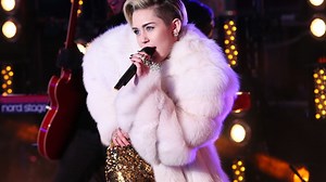Miley Cyrus dresses in ''the most clothes'' she's been in all year for New Year's Rockin' Eve performance