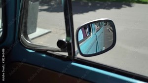 Blue retro bus driving in a city