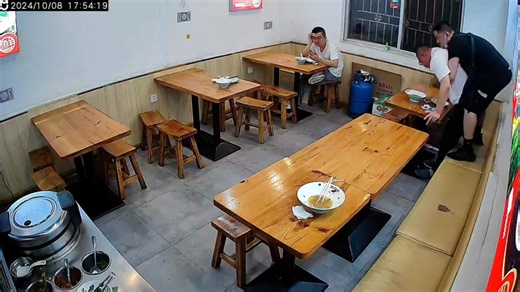 Restaurant owner rescues diner choking on food while young man gazes at his phone