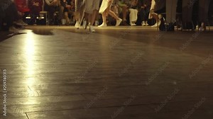 Female models walk the runway in different dresses during a Fashion Show. Fashion catwalk event showing new collection of clothes. In a row. 4k