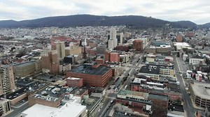 City of Reading, PA, aerial pullback reveals downtown financial district and sprawling residential urban neighborhoods