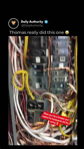 This isn’t just messy wiring — this is a serious fire hazard waiting to happen. Smoke is visibly rising from inside the electrical panel, breakers show burn marks, and bare copper wires are twisted around switches in ways that clearly violate safety standards. Different breaker types are forced together, grounding appears improper, and exposed wiring hangs loosely outside the box. To make matters worse, the panel is installed near water lines inside a bathroom, surrounded by combustible material