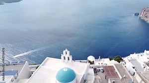 Famous Greek island of Santorini and the town of Thira, aerial view of popular resort in Greece, flying above colourful houses of Thira, amazing romantic town in Greece.