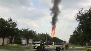 A pipeline explosion sends a towering pillar of flame over Houston's suburbs