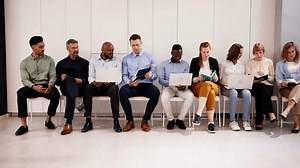 Row Of Diverse People Waiting For Job Interview In Office