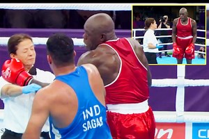 IRON CHIN Female referee shrugs off wild, swinging punch from super-heavyweight boxer at Commonwealth Games