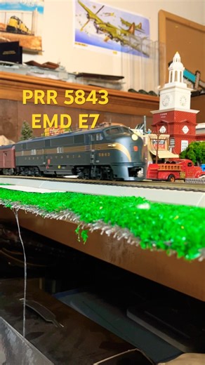 Pennsy passenger train rolling by downtown. Ho scale model PRR train EMD E7.