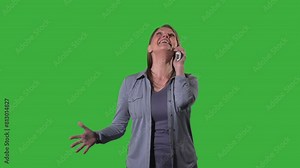Woman laughing hysterically while on the phone green screen