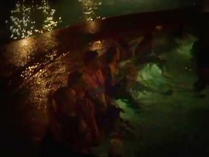 Bride and Groom jump in the pool and all the wedding guest follow. (wave)
