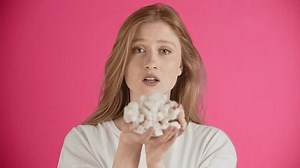 The girl experiences sublime sadness, cries and tries to correct guiltiness. Emotions of sentimentality and remorse. Young woman gives a present and wants reconciliation. Looks at camera.