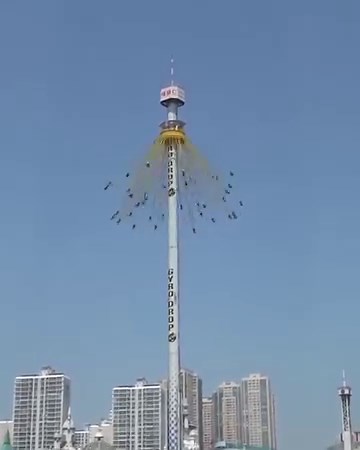 Gyro Drop, a 315-foot tall tower at the amusement park Lotte World Adventure in Korea. It features a large rotating ring of 40 seats that lifts passengers high into the air and then drops them back down with a free fall. Oh, and guests can also choose to wear a VR headset while riding. If that wasn't scary enough someone decided to edit this video to make it even more terrifying. | GritDaily.com