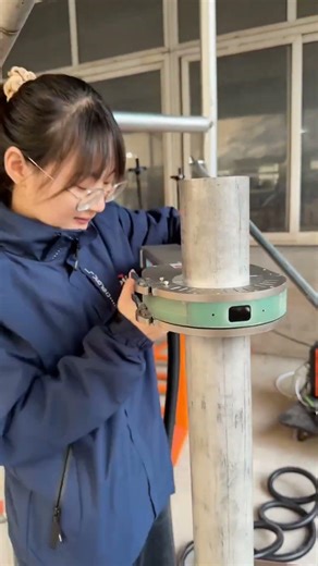 Woman Joining Metal Pipes with a Powerful Machine