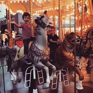 All smiles on a carousel ride! | Irvine Spectrum Center
