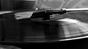 old retro turntable with classic records. Rotating vinyl record on vintage music turntable. stylish black and white video