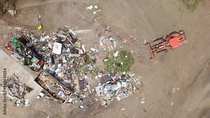 Waste sorting - Aerial footage of workers manually sorting types of waste at a local recycling facility.