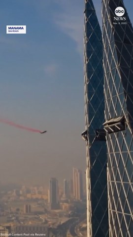 Wingsuit flyers perform daring crossing between towers