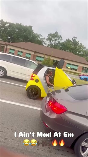 Yellow SmartCar with Lambo doors in traffic