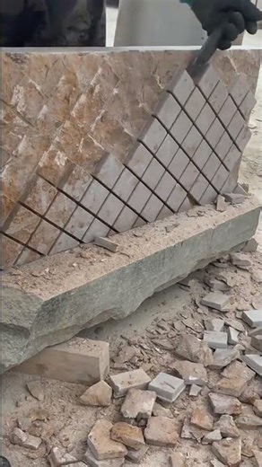 performing a precise manual stone masonry process to carve out a diamond or square