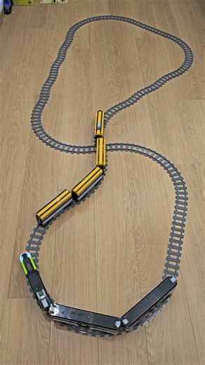 LEGO trains on a warped figure-eight track follow each other perfectly