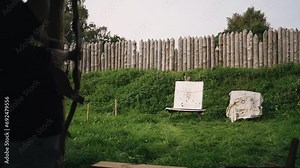 A woman shoots an arrow at a target on a shooting range. The flight of the arrow was filmed in slow motion