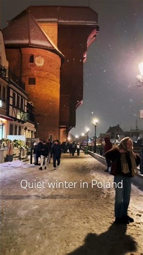 Snow falling over medieval streets
