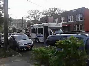 An Access-A-Ride Bus making a pass through for pick-up