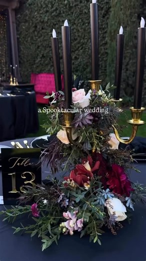 A little Halloween magic, but make it wedding chic 🖤 Black candles, deep burgundy blooms and what felt like thousands of flickering lights… the most hauntingly romantic tablescape for an autumn “I do.” Would you dare to have a Halloween-inspired wedding? Credit: @mooredecor_partyrentals | Weddings & Honeymoons Magazine