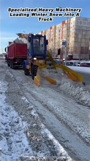 Specialized Heavy Machinery Loading Winter Snow Into A Truck
