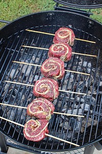 Cheesy Steak Pinwheels are epically delicious! 🥩 🧀 🔥 As a child, I was always told not to play with my food. Little did they know that I would do that as an adult all the time! These Cheesy Steak Pinwheels are no exception to that rule. Filleted open center cut beef tenderloin stuffed with mustard, cheese and prosciutto. We will then roll these guys up, skewer and slice into individual steaks to be grilled on the Oklahoma Joe's Smokers Blackjack Kettle Grill. Topped with Spicy Gremolata, this
