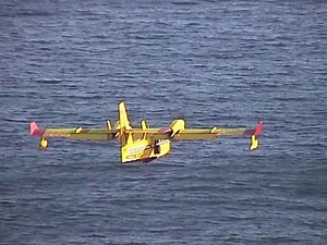 Skilled pilot in Bombardier 415 Super Scooper Water bomber. Fighting Fires in Naples Bay, Italy.
