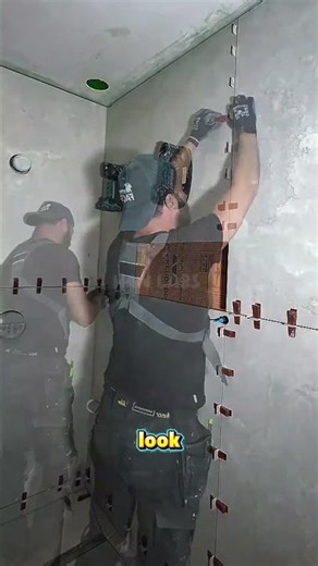 Large-format wall tile installation with high precision and professional techniques.