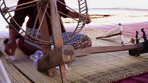 Download Close-up of a woman spinning thread in a spinning machine which is a tool used to spin cotton into tight threads threads. Thailand traditional. for free