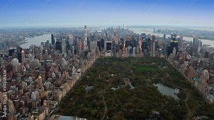 Beautiful aerial view of Central Park in Midtown Manhattan. Iconic skyscrapers as the Freedom Tower and the Empire State Building in the background. New York, United States. Shot from a helicopter