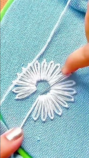 hand stitching beautiful white flower patterns using embroidery needle
