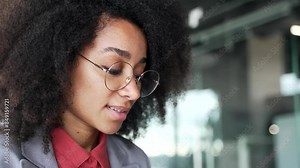 Young african american businesswoman typing on laptop in business office. Black woman working in computer application, banking, texting a client, chatting online or busy with a project. Close up