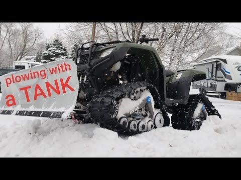 ATV with TRACKS plowing snow
