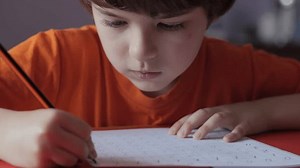 School Boy Practicing Writing Numbers at Home. Child Working on His Homework. Little Boy Studying Learning at Home. Child, Learning Doing Math for Education, Making Homework Numbers in His Room.