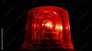Illuminated red siren light in a dark setting, conveying urgency and emergency