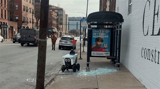 Delivery robot struggles through glass shards after crashing into bus shelter